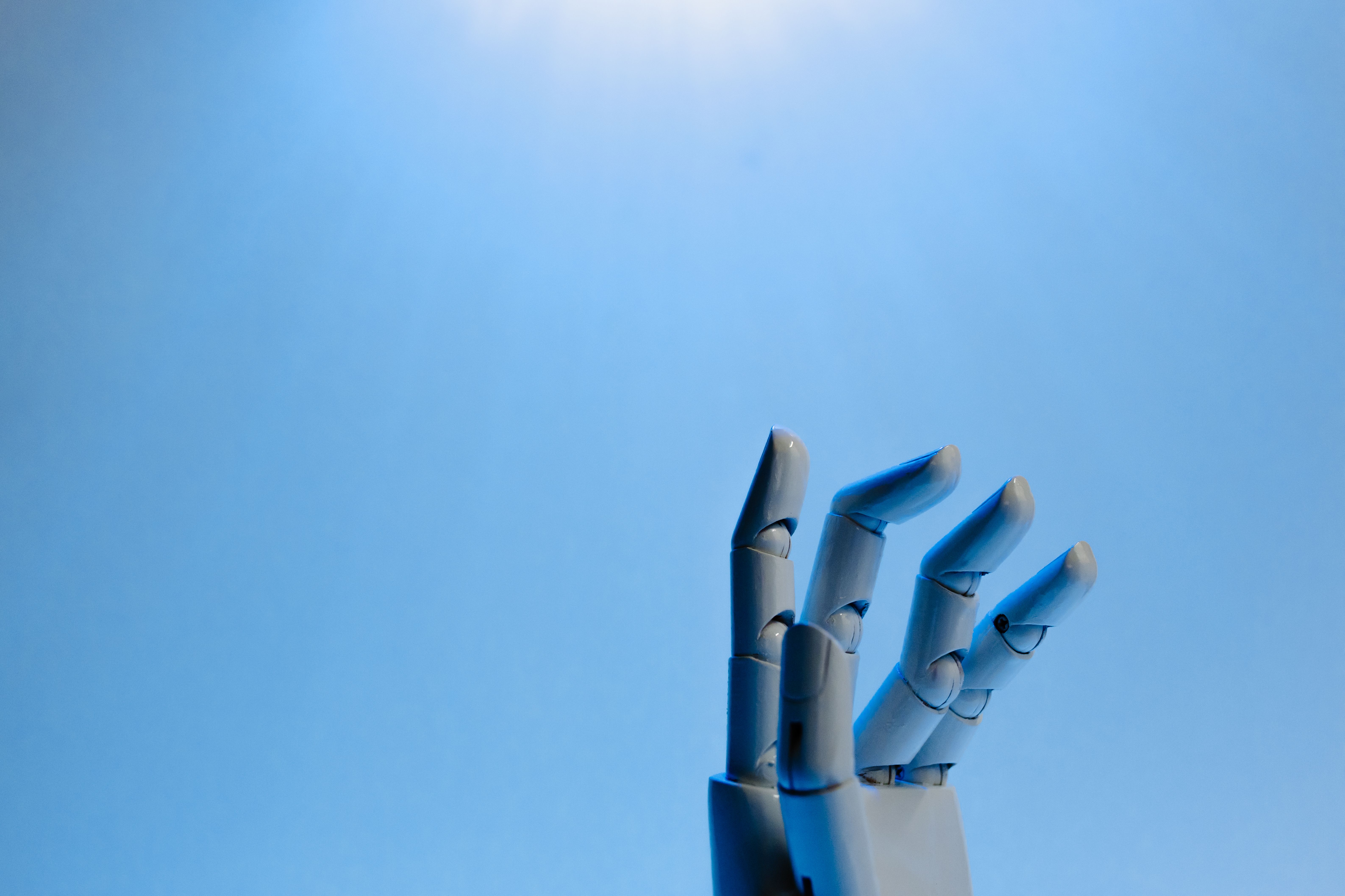 Illustration photo of a robotic hand reaching upward, representing an AI agent taking autonomous action