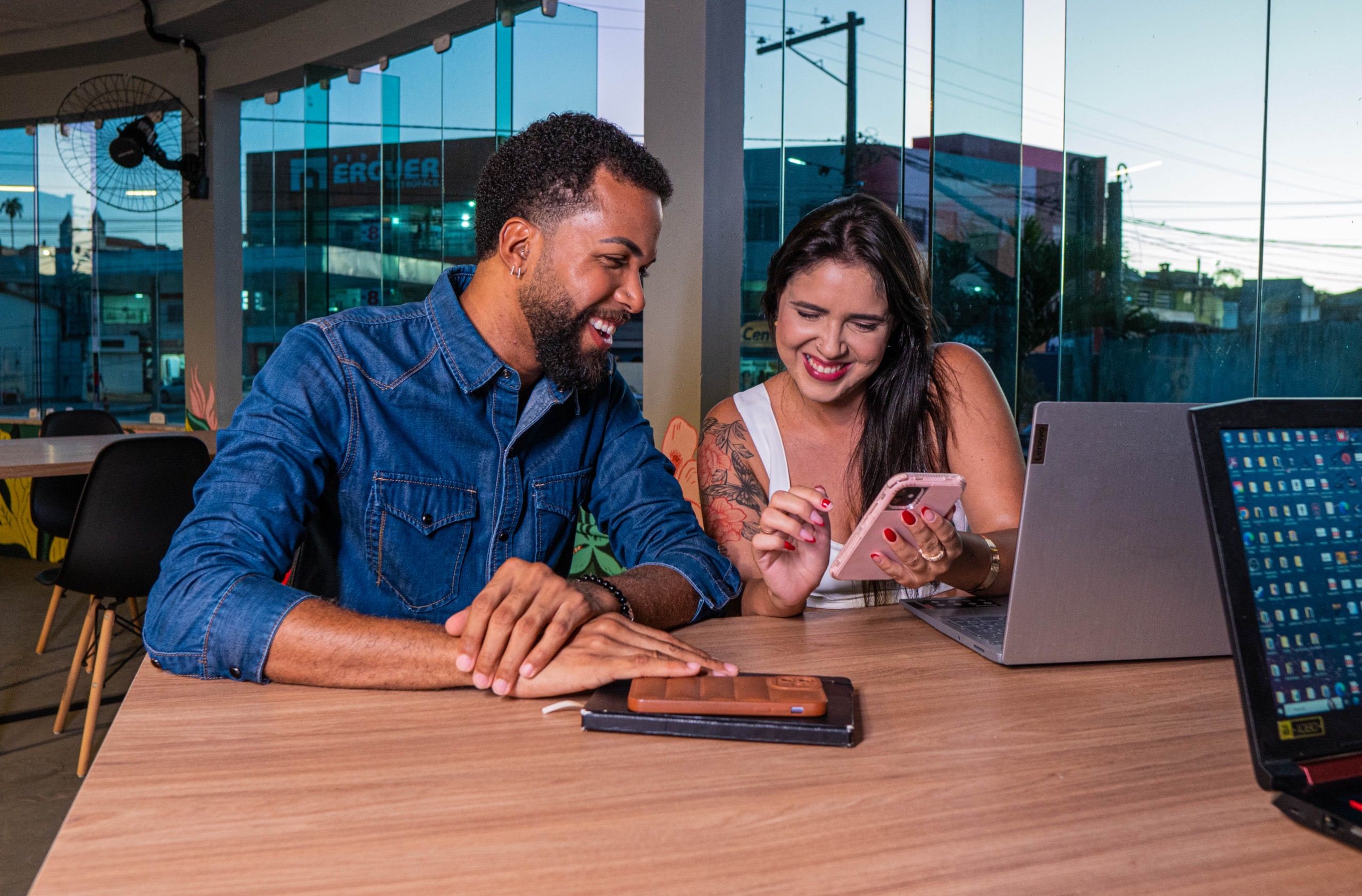 Small team reviewing a shared task list on a smartphone