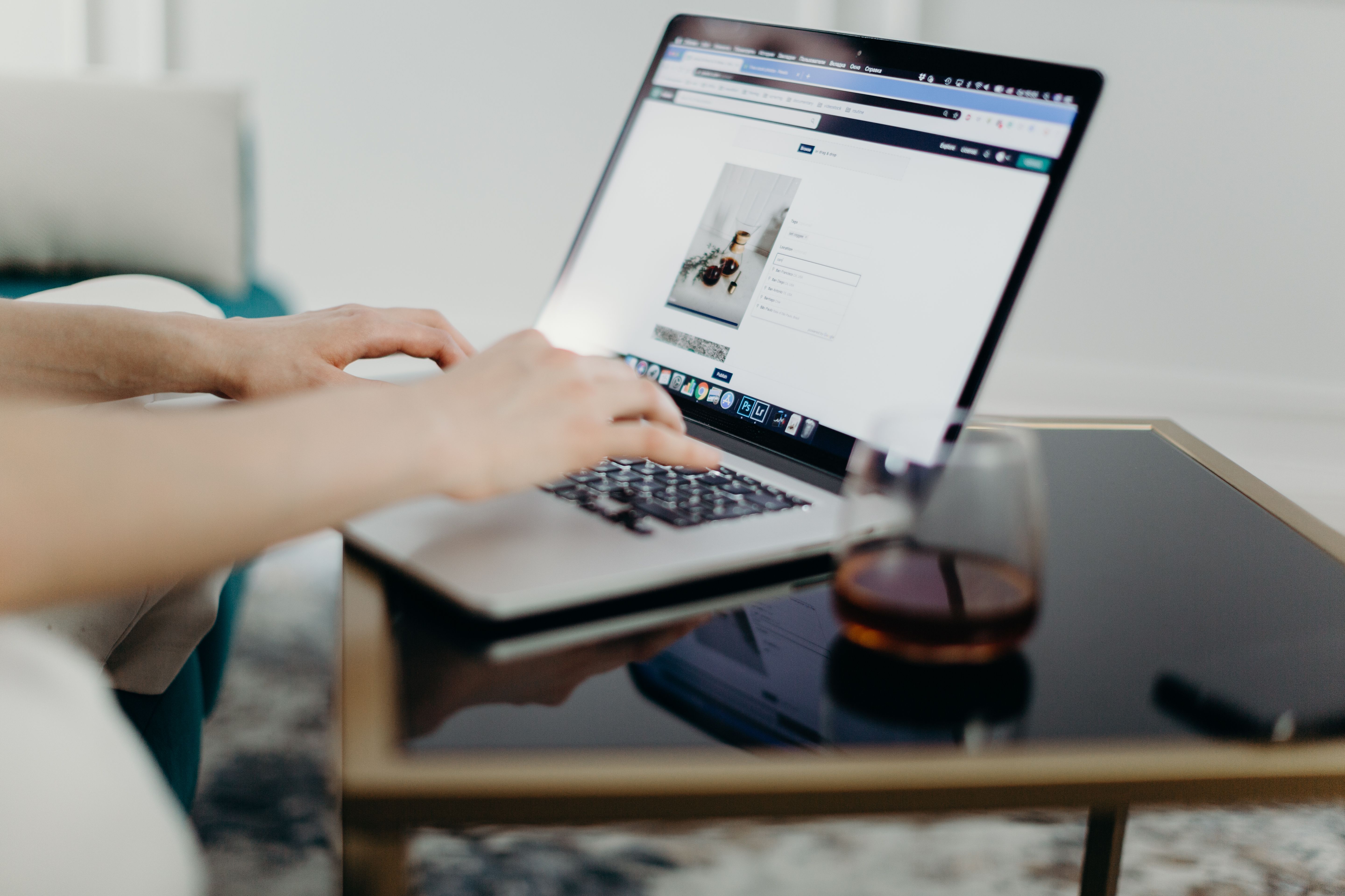 Person reviewing a website on a laptop in a working environment