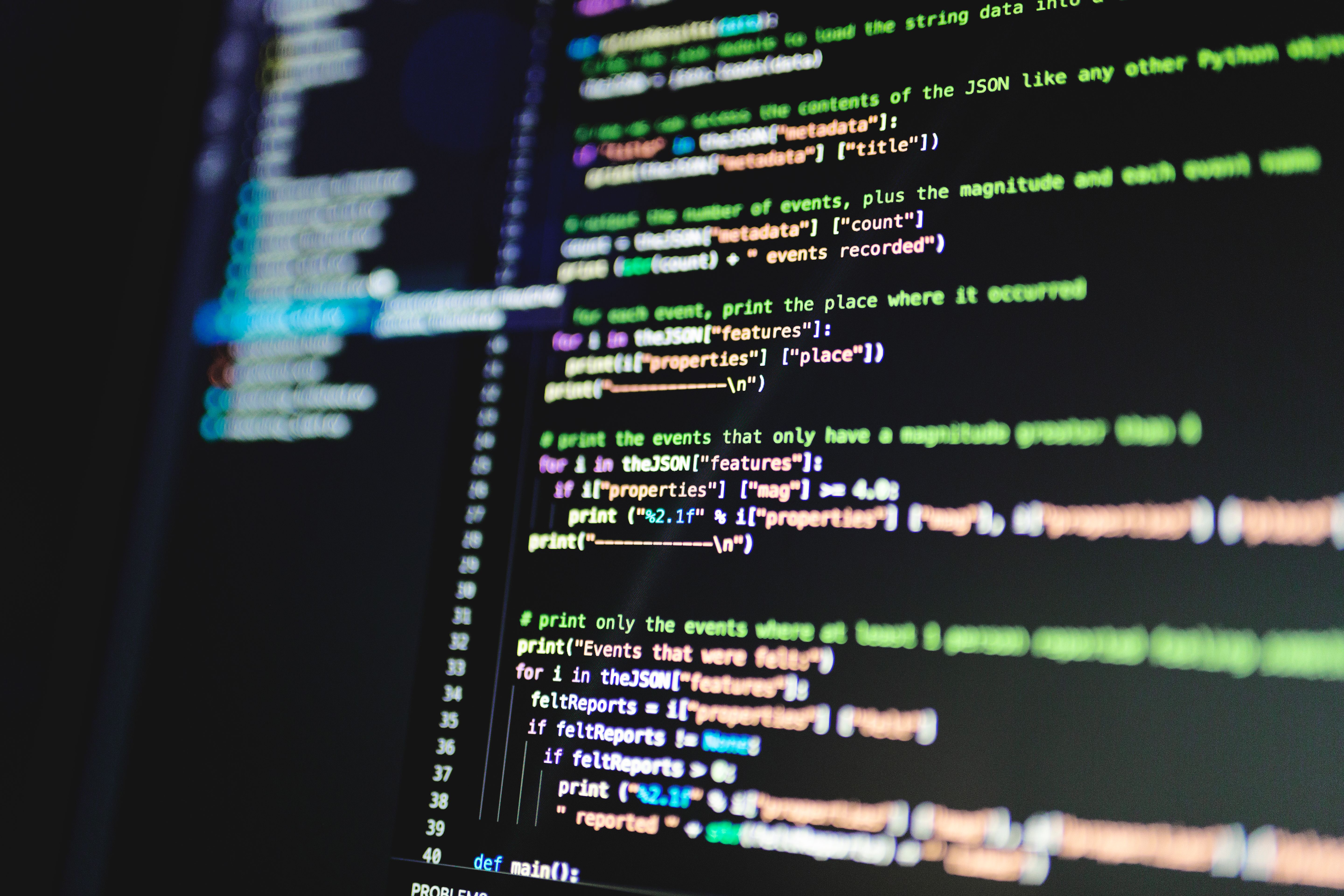 Close-up of programming code displayed on a developer monitor screen in a software engineering workspace