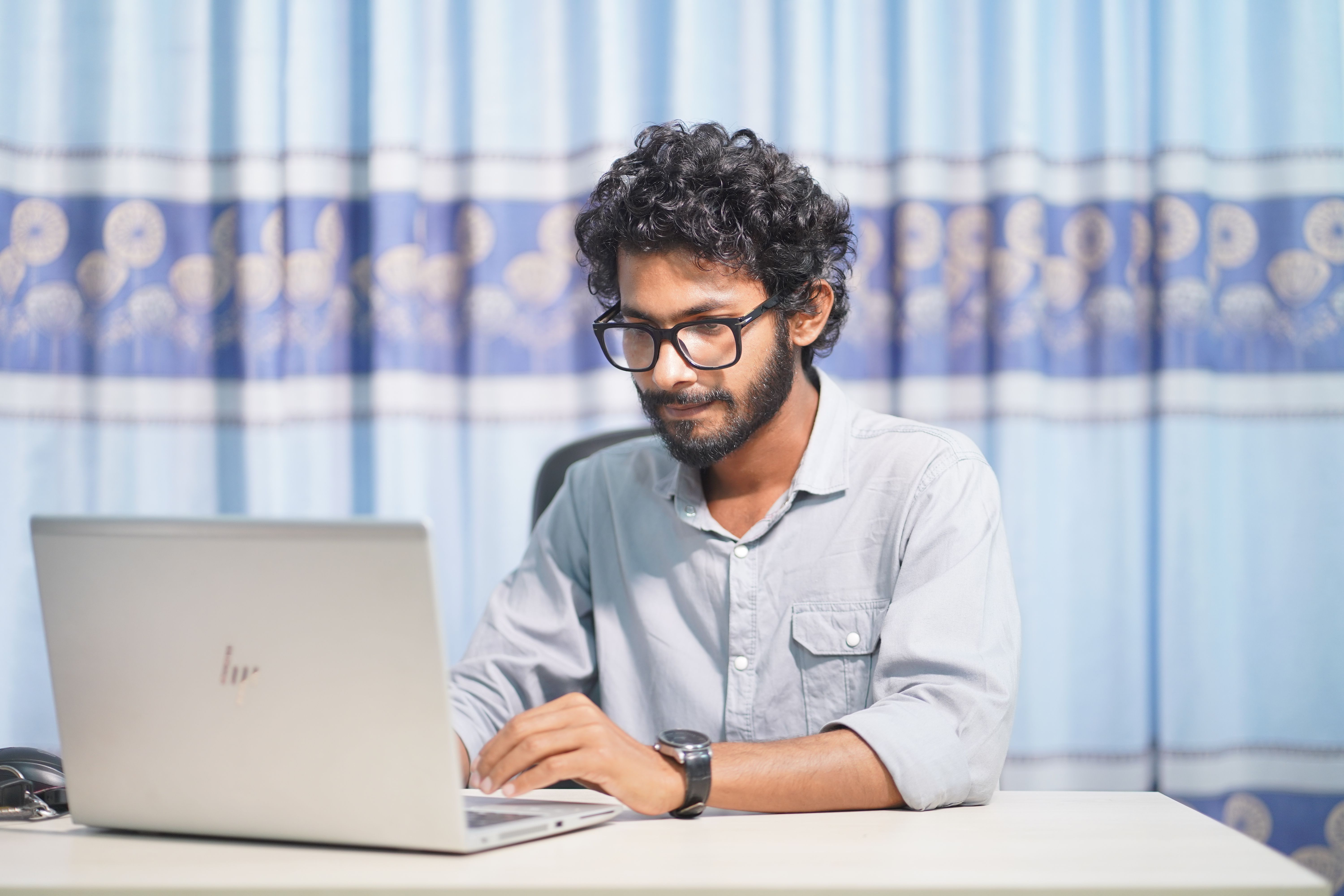 Person working on a laptop in a bright room.