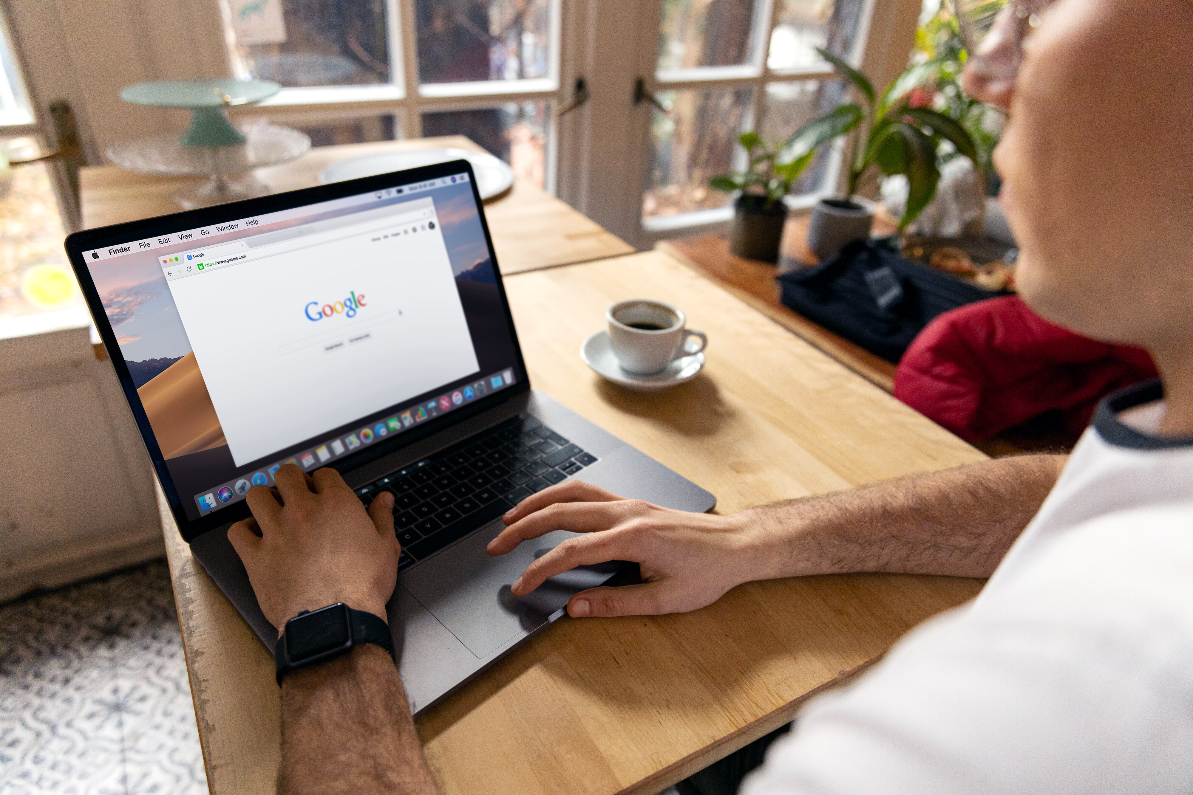 Photograph of a laptop with a browser window open on a work desk.