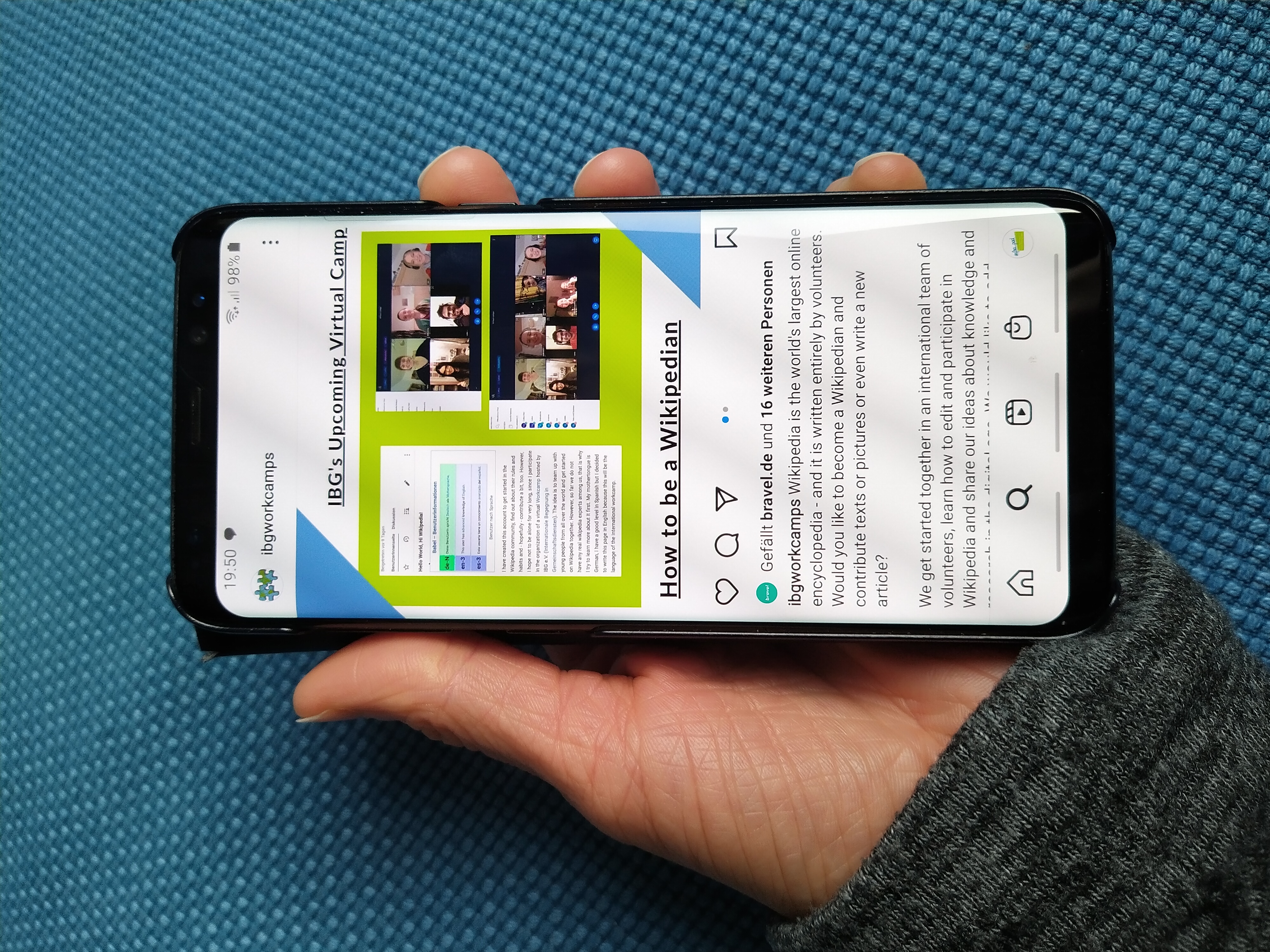 A hand holding a smartphone browsing a website