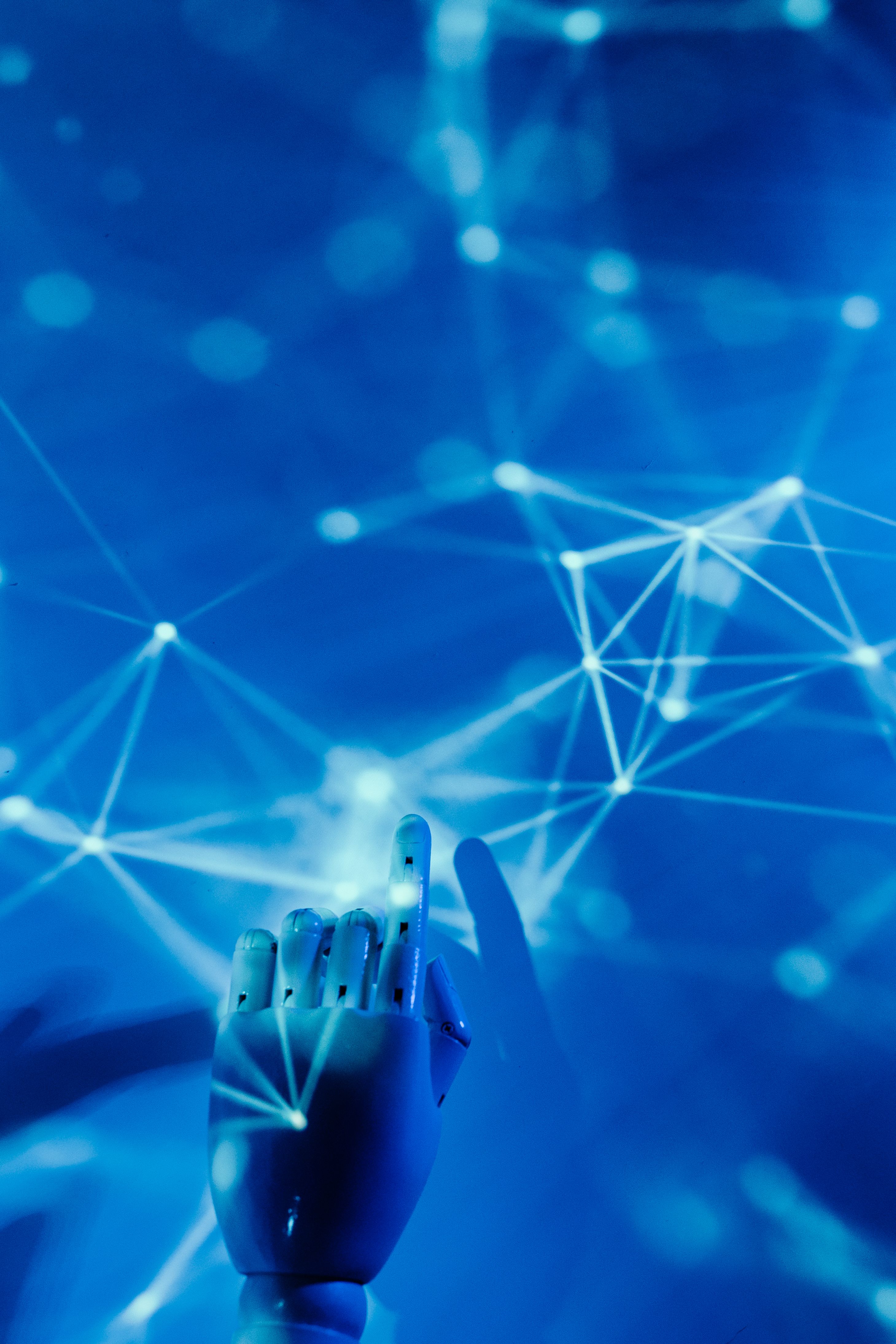 Illustration photo of a robotic hand touching a digital network, representing an AI agent