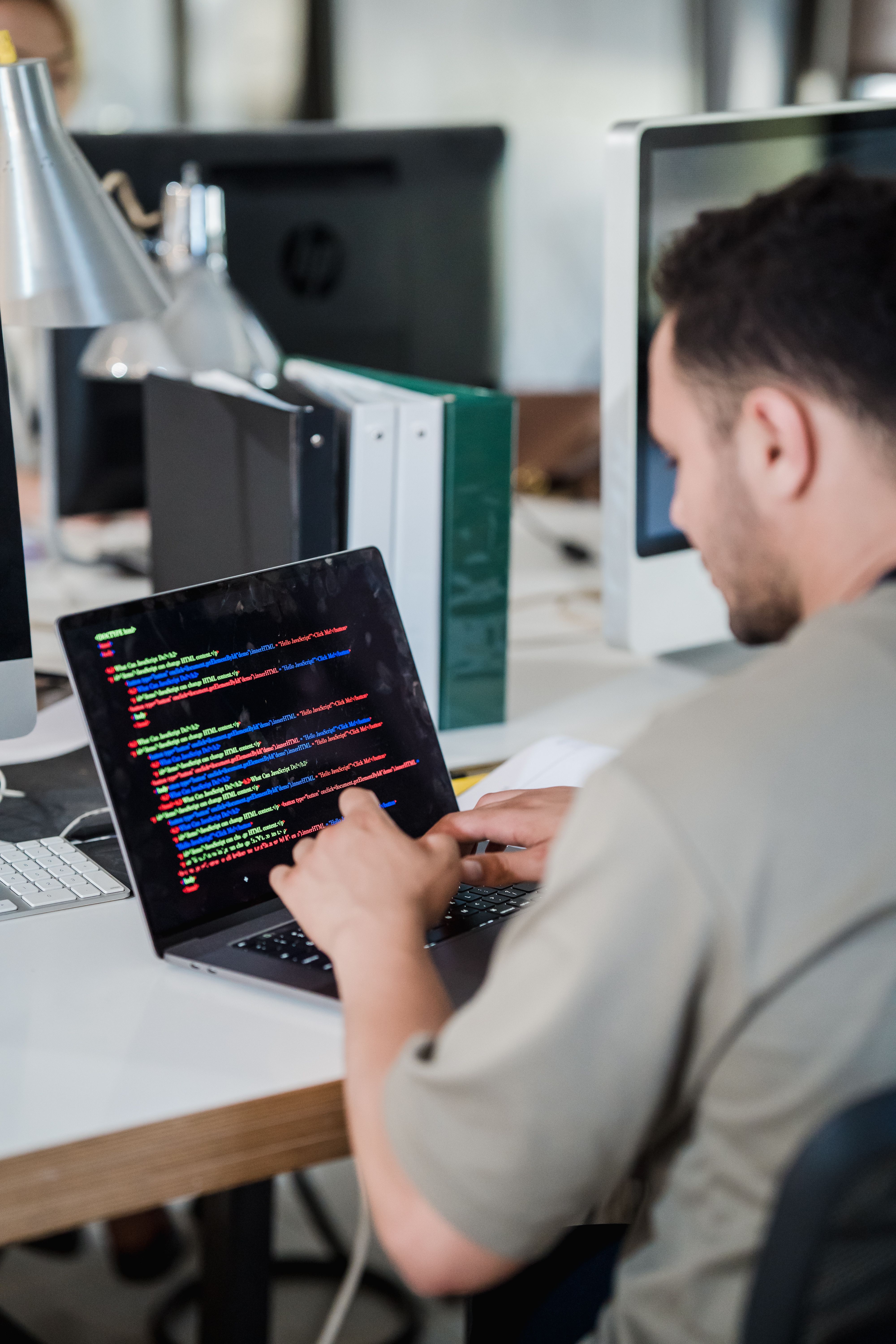 Illustration photo of a software developer typing code on a laptop
