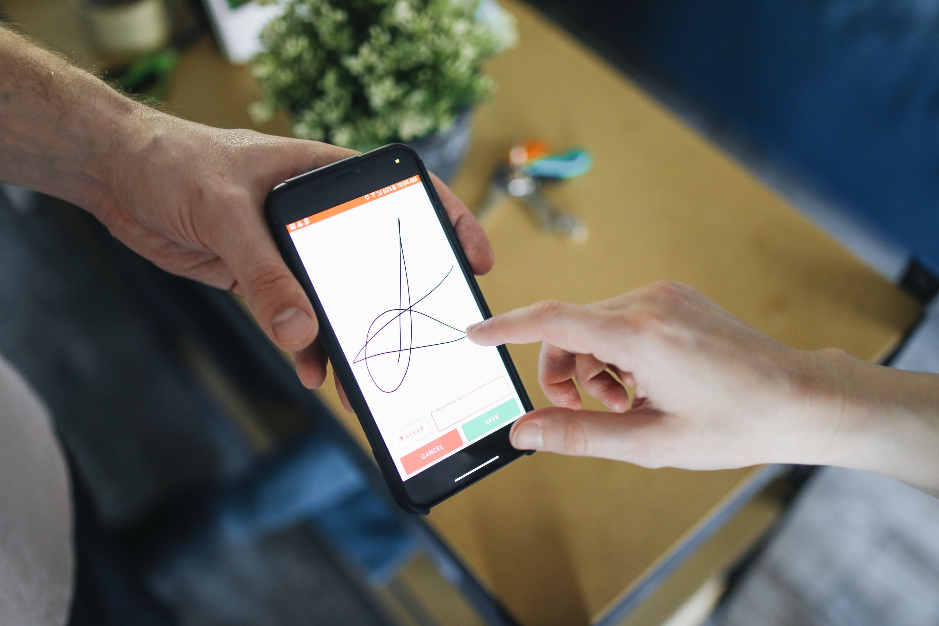 Person holding a smartphone completing an electronic signature verification in a modern digital environment
