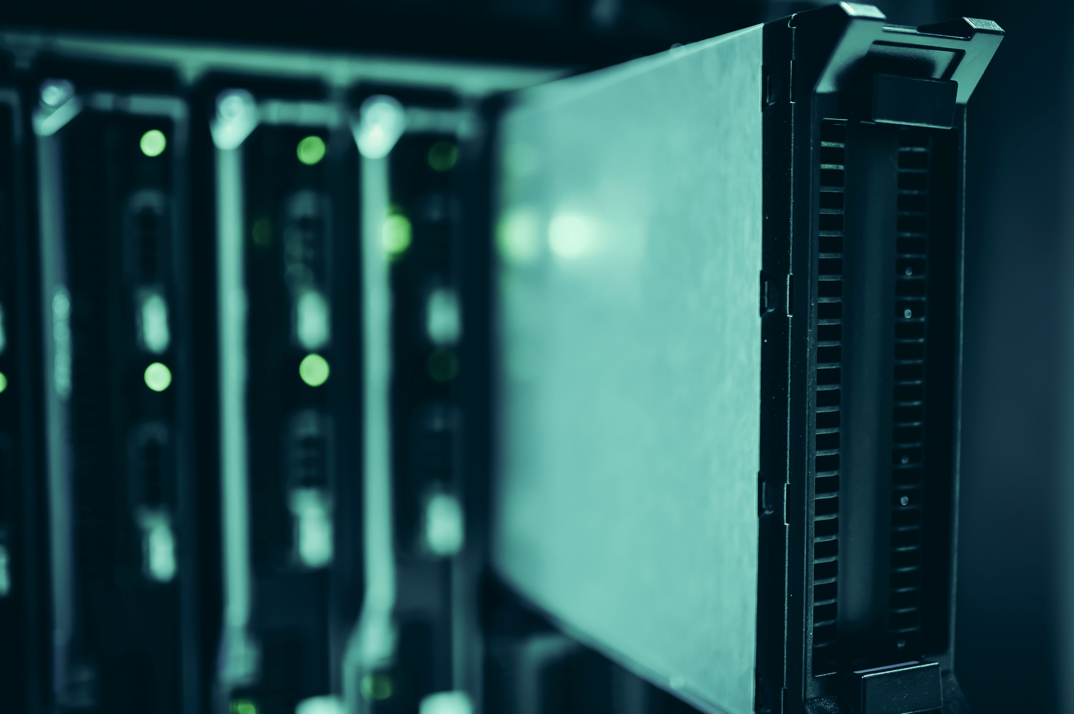 Close-up view of illuminated server racks and network switches in a modern data center environment.