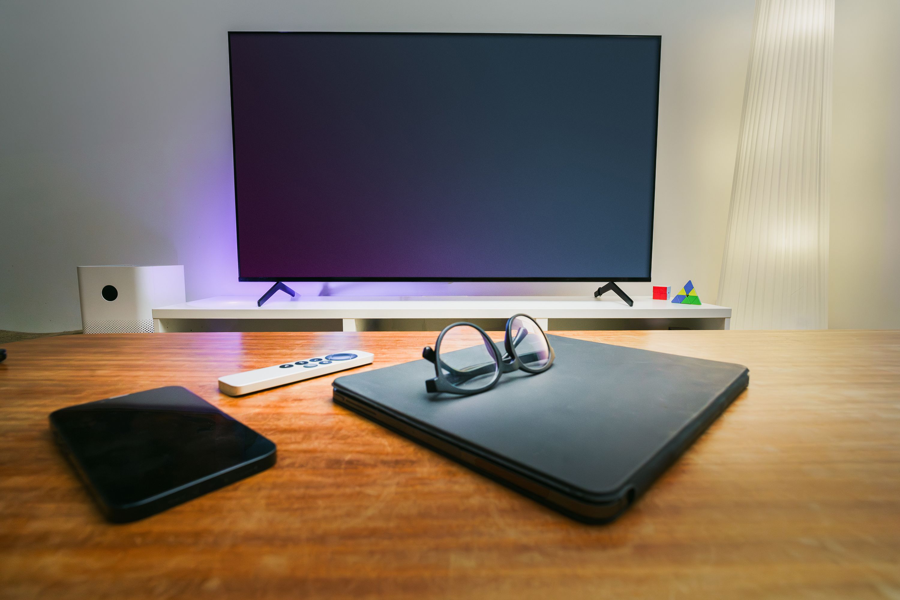 Modern cozy living room setup with smart home ambient lighting and connected interior devices.
