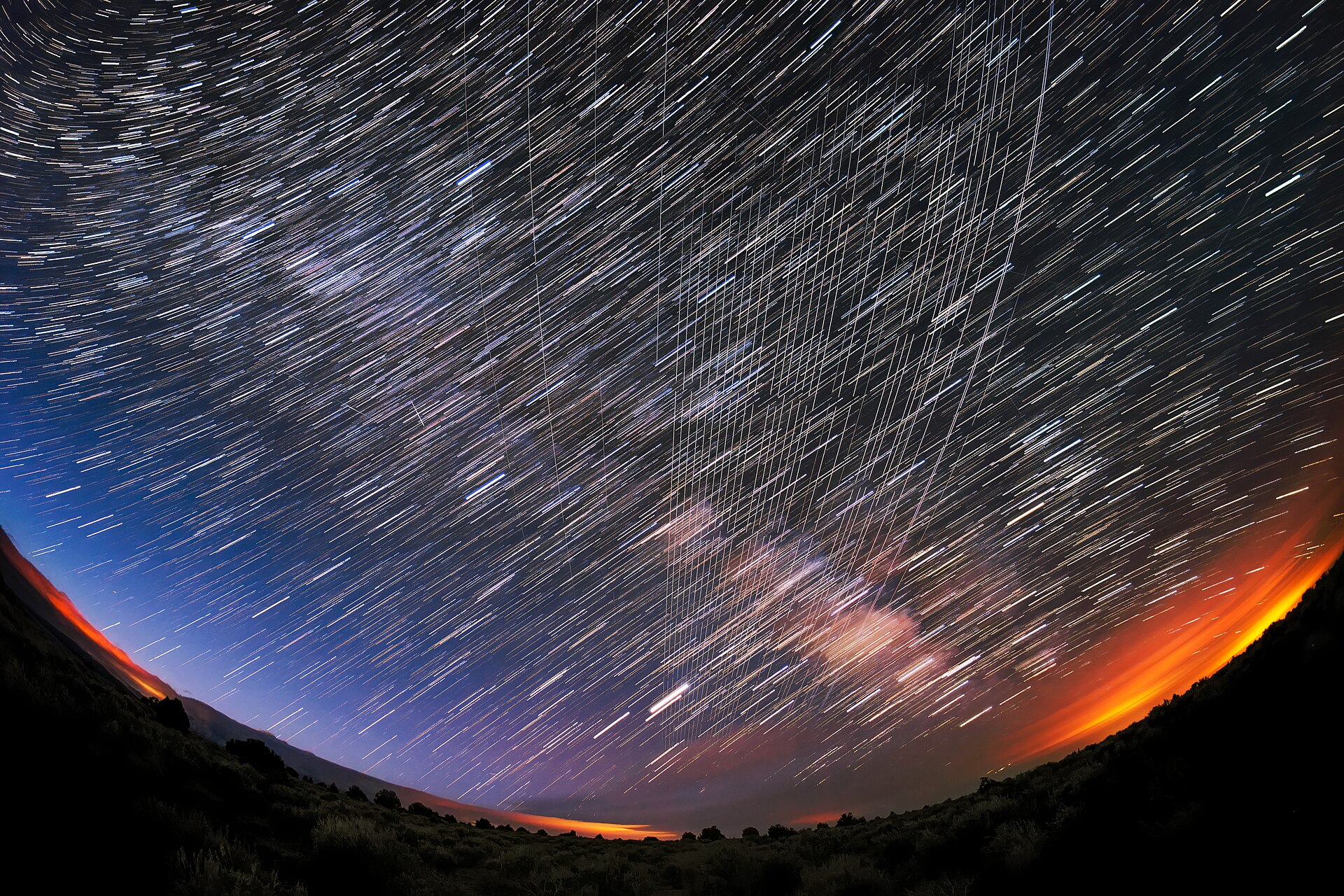 Starlink satellites passing overhead in a trail across the night sky near Carson National Forest, New Mexico.