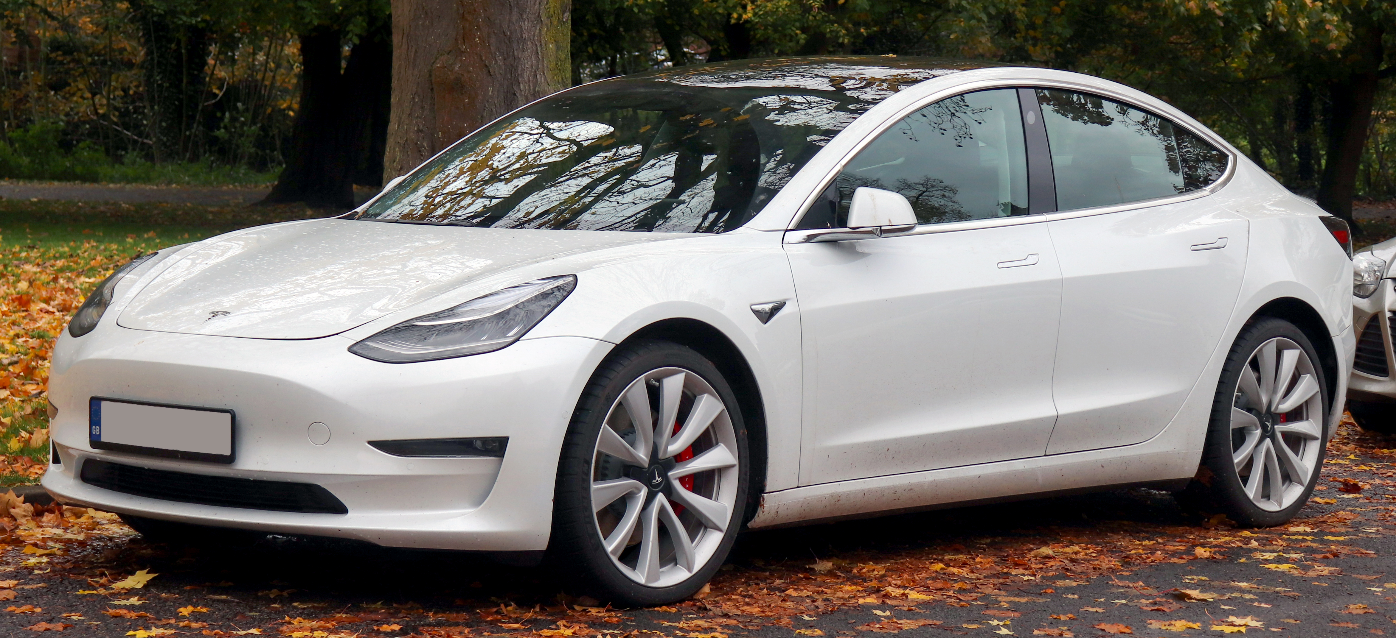 A Tesla Model 3 Performance electric car on a European street.