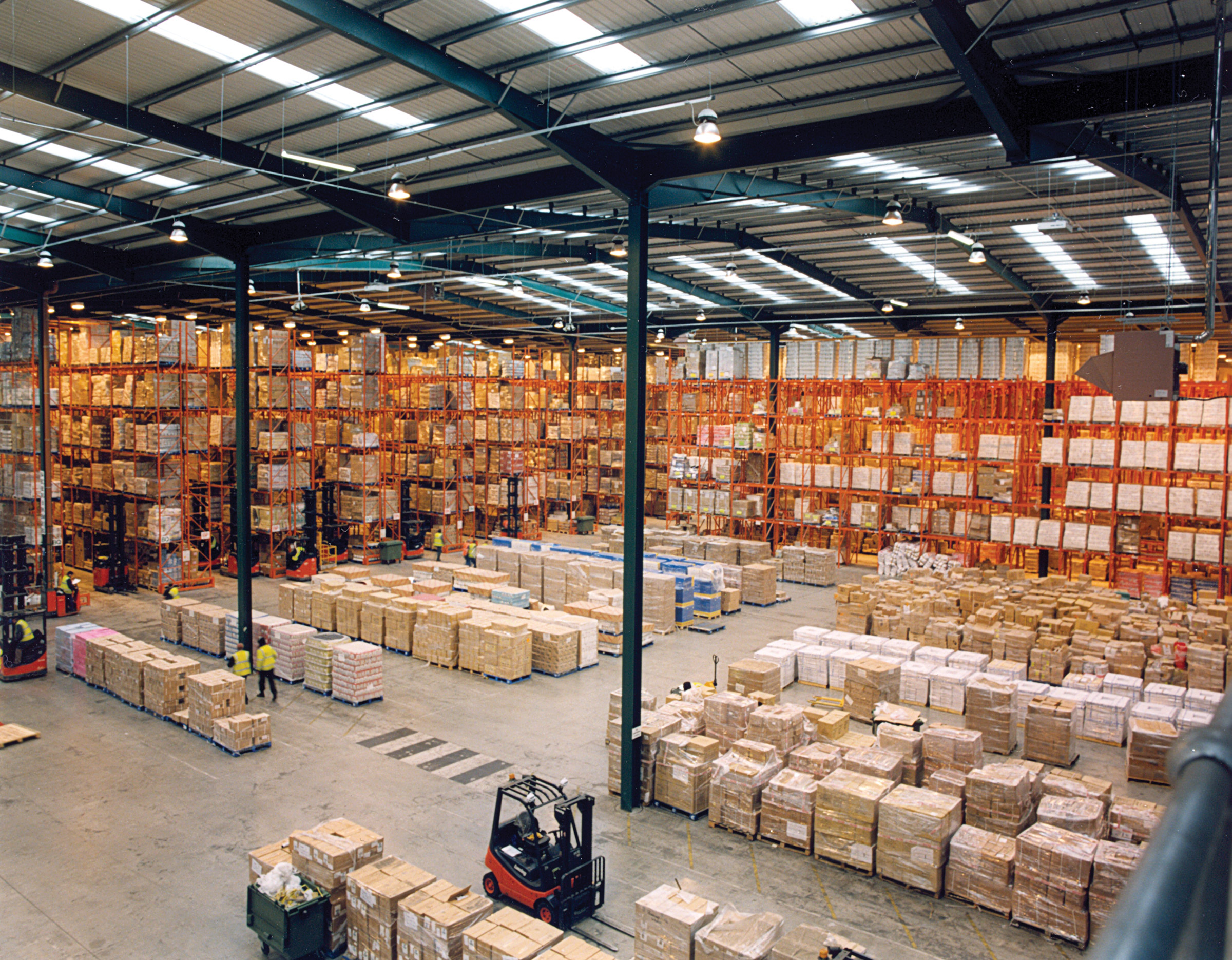 Photograph of a modern warehouse with a multi-tier pallet rack storage system