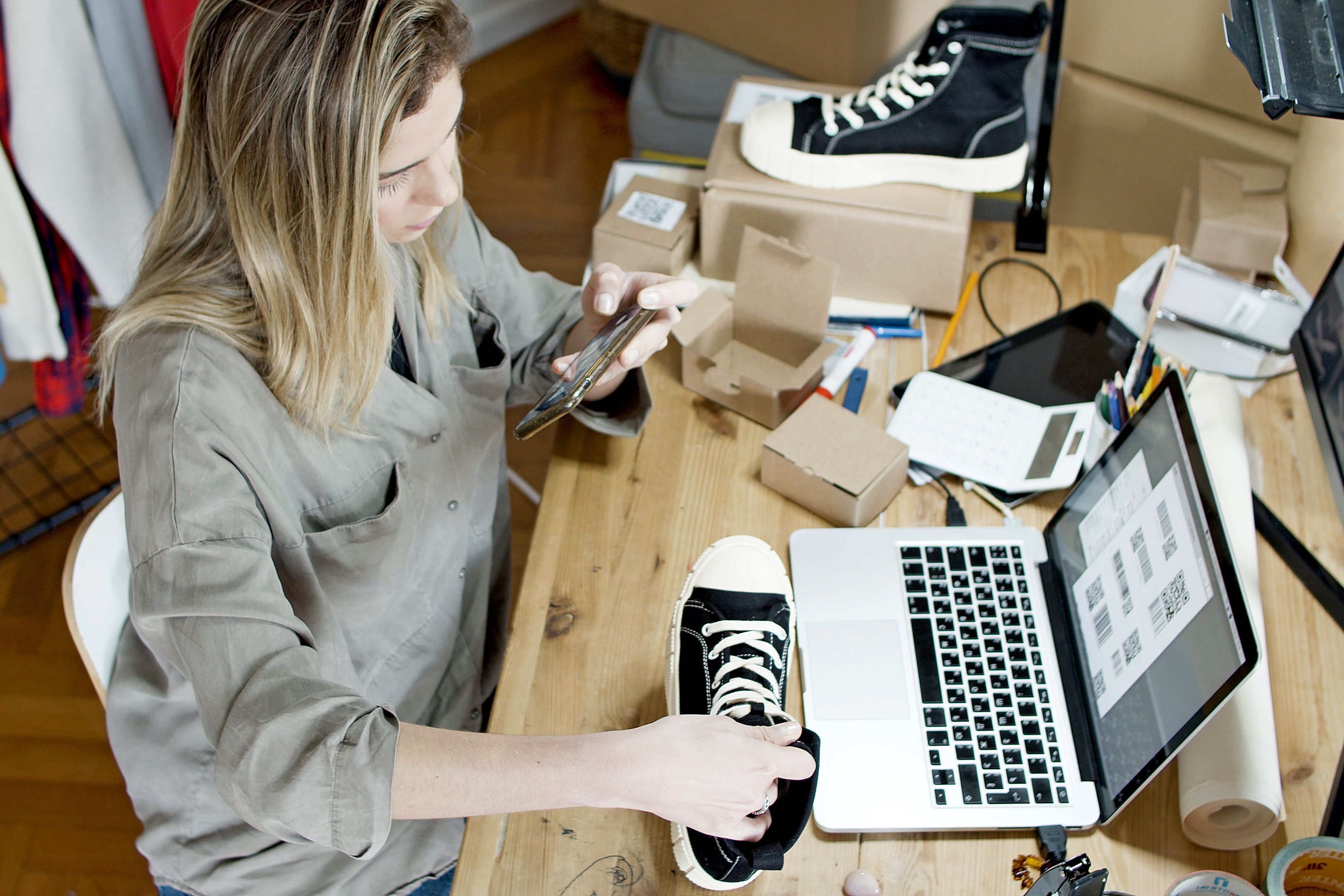 Small business owner photographing product for online shop - illustration
